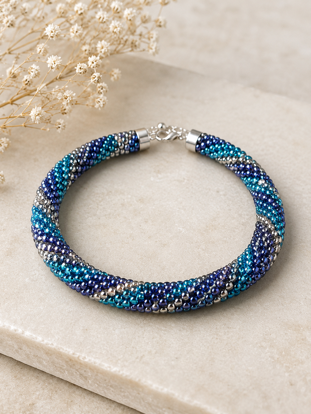 Handgefertigtes Glasperlenarmband „Ocean Twist“ – Spiralarmband in Blau, Türkis & Silber mit Knebelverschluss